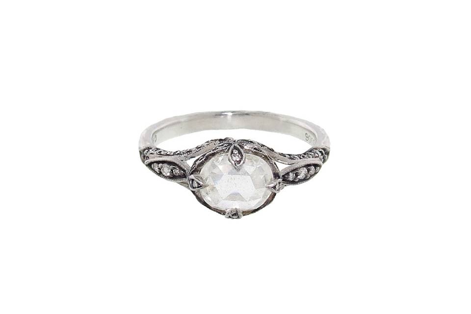 An absolute stunner from Cathy Waterman, this classic design is a diamond solitaire with a center oval rose cut moghul diamond that totals 1.01 carats. It is prong set in her beautiful, raised petal side frame with blackened detail and diamonds and rests on a platinum hammered band. Total carat weight is 1.18cts