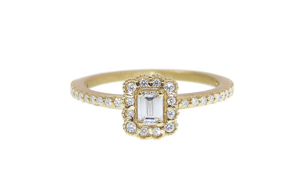 Megan Thorne's rings have an Old World feel with a sensibility to what her younger generation loves. This Mosaic Emerald Cut Ring in 18 karat yellow gold has a .25 carat emerald cut diamond that is framed in a scalloped diamond setting. Worn alone or with one of Megan's diamond bands, the detailing is so beautiful, it is certain to become a family heirloom. <p>Each Megan Thorne ring carried by Ylang 23 is in rose cut or brilliant diamonds, or a combination of both, and not with white sapphires (although her solitaires can be special ordered with white sapphires). Megan casts, fabricates and hand finishes every piece, and therefore can accommodate special orders of solitaires in many sizes and shapes.