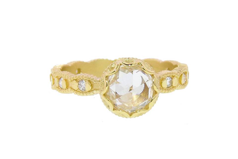 Megan Thorne's rings have an Old World feel with a sensibility to what her younger generation loves. This Scalloped Bezel Ring is amazing, with a 1.30 carat H/SI1 EGL Certified rose cut diamond in the center that rests on a ribbed scalloped band with diamonds in 18 karat yellow gold. Worn alone or with one of Megan's bands, the detailing is so beautiful, it is certain to become a family heirloom.