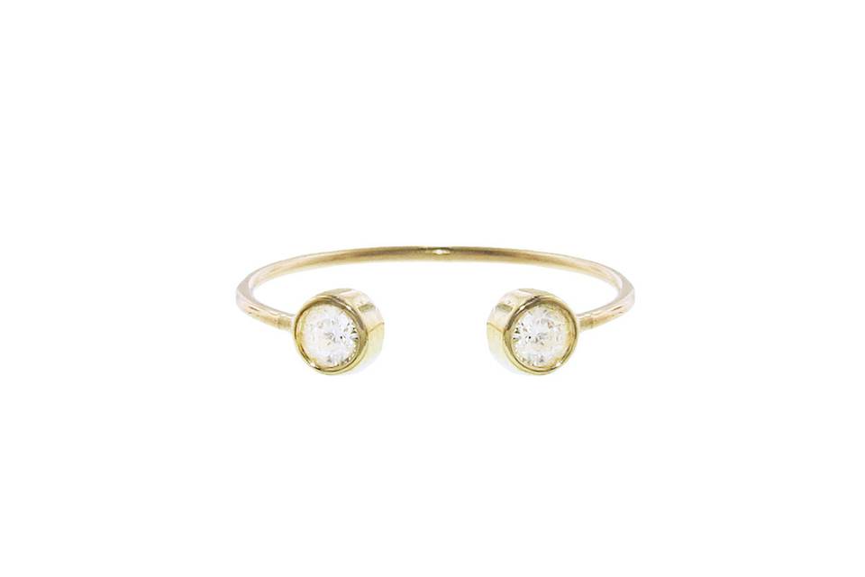 A gorgeous ring by Jennifer Meyer that is perfect for everyday! This ring features two diamonds that are bezel set in 18 karat yellow gold and rest on a thin band. This ring has an open center, allowing for endless stacking possibilities!