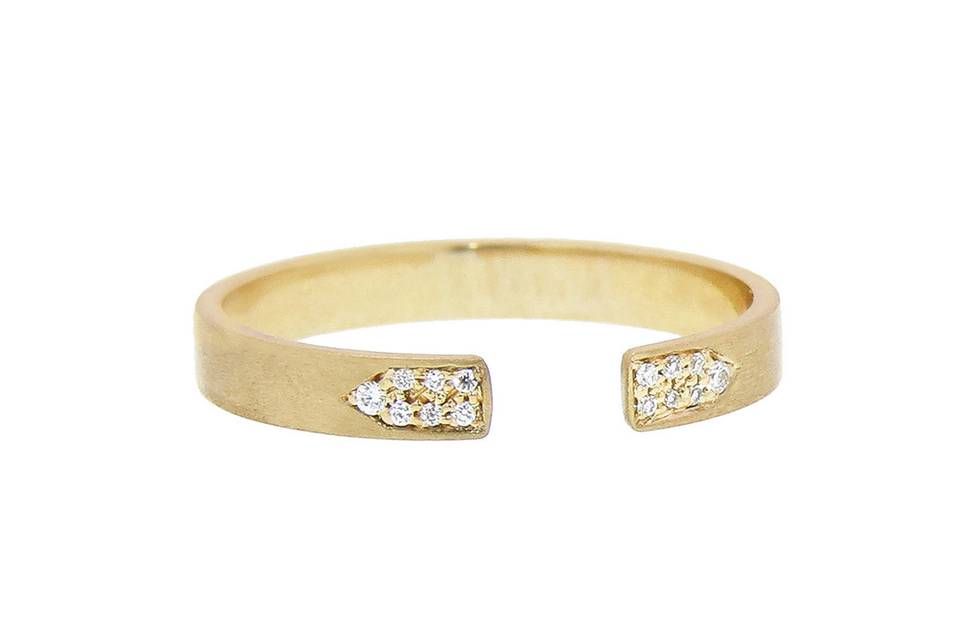 This open, 14 karat yellow gold ring from designer Jade Trau is accented with diamonds, creating a very unique look. The band is 3/16