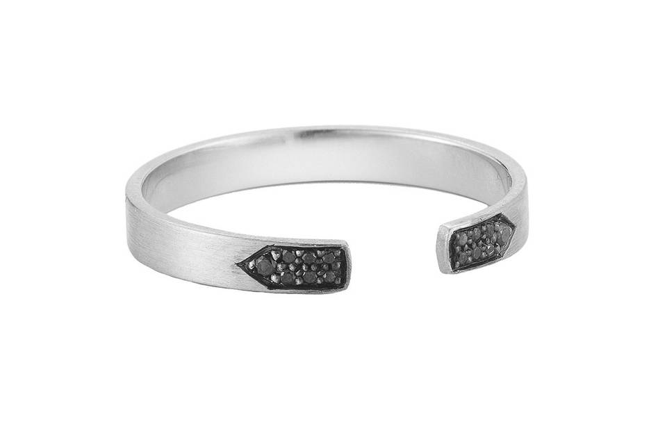 This 14 karat white gold ring from designer Jade Trau is accented with black diamonds, creating a very unique look. The band is 3/16