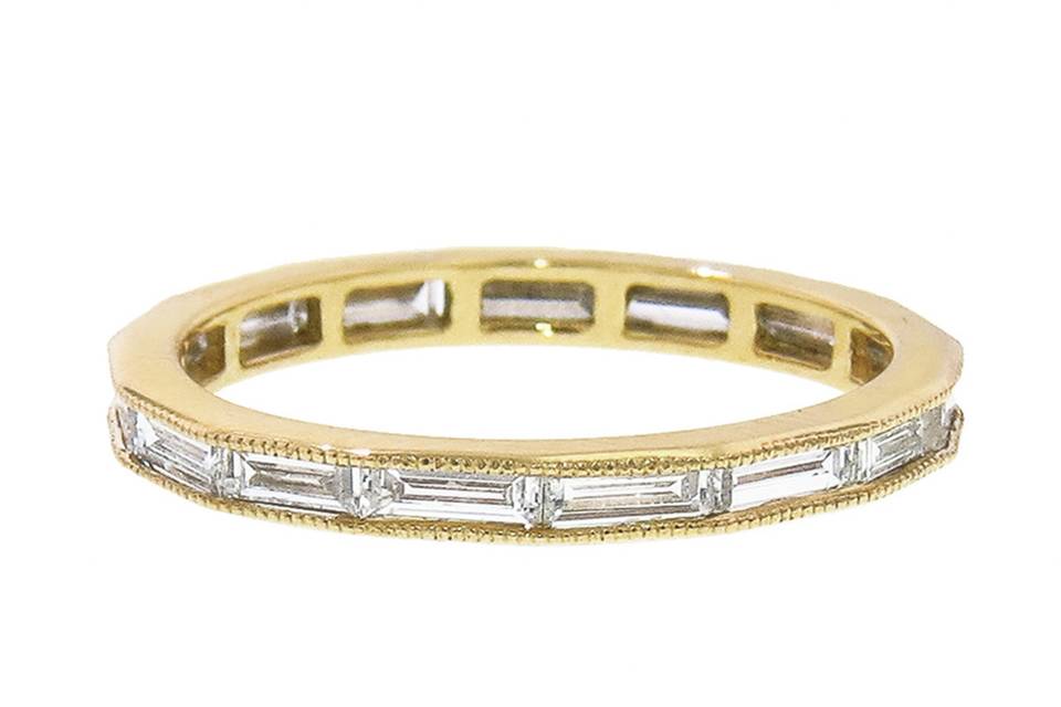 This gorgeous ring from jewelry designer Sethi Couture is a lovely display of baguette diamonds channel set in a band of 18 karat yellow gold. The band looks amazing stacked. The diamonds share a carat weight of 1.15 carats.