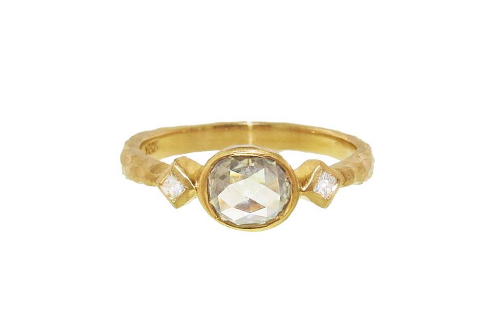 This classy ring from Cathy Waterman is one of our favorites! A .67 carat grey diamond rests in the center of the band and is bezel set in 22 karat gold. The grey diamond rests on a thick hammered band finished with two thorn ends each detailed with a sparkling diamond. This ring looks amazing stacked with Cathy's other thin thorn bands.