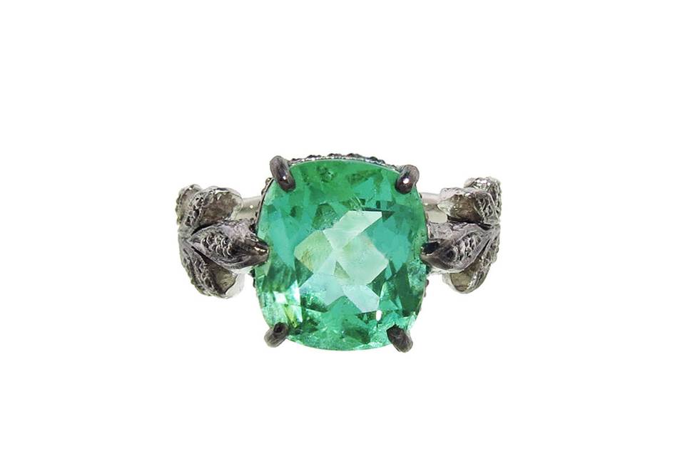 This leaf ring from Cathy Waterman has a beautifully faceted emerald with a carat weight of 4.03 carats. The bright emerald pops against the darkened setting. Detailed by hand this ring has been lovingly prong set in blackened platinum with bright sparkling diamonds. The dazzling emerald is flanked by diamond leaves and rests on a textured bark band.