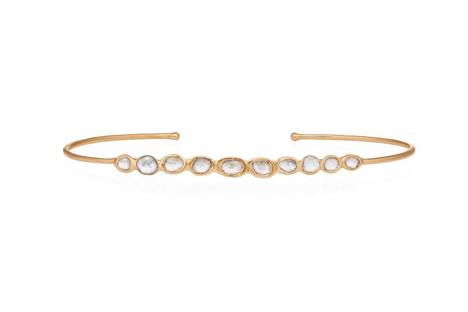 Freshen up your everyday stacking collection with this gorgeous bangle from Celine Daoust. This bracelet features ten polki diamonds that are individually set in 14 karat yellow gold. It measures 2 1/4
