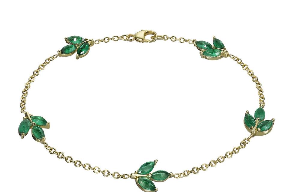 This dainty bracelet from Finn has 5 leaves of marquis emeralds set in 18 karat yellow gold. Measures 6 1/2