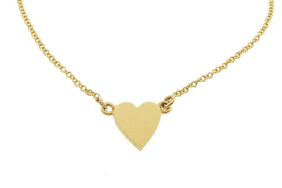 So loveable from Jennifer Meyer, this dainty bracelet features a tiny, 18 karat yellow gold heart that dangles from delicate 14 karat gold chaining. Stretches 6 1/2