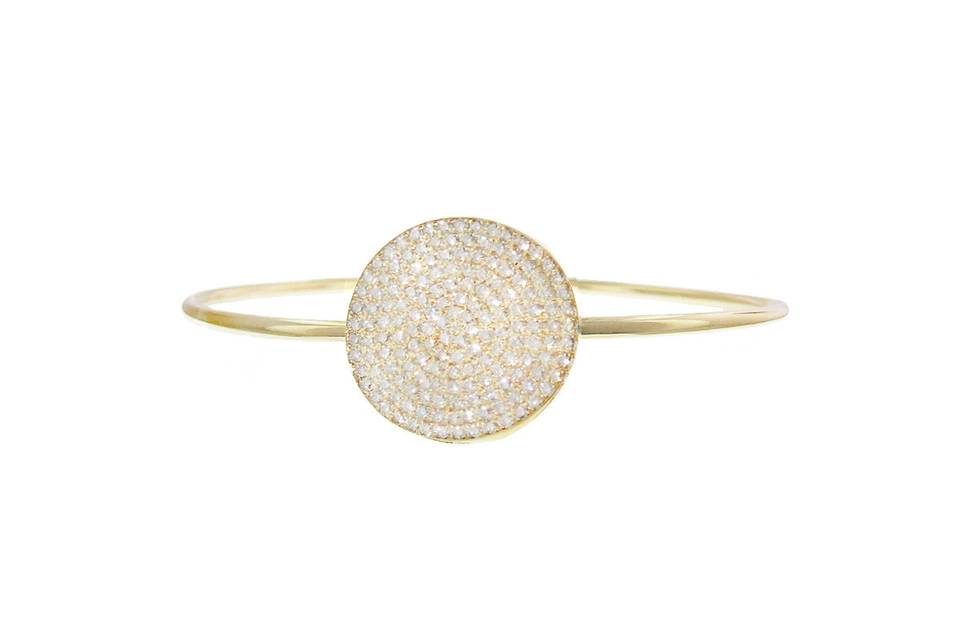 This gorgeous bangle from Jennifer Meyer is detailed in 18 karat yellow gold and features a large pave diamond disc in the center of a thick wire bracelet. The disc measures 3/4