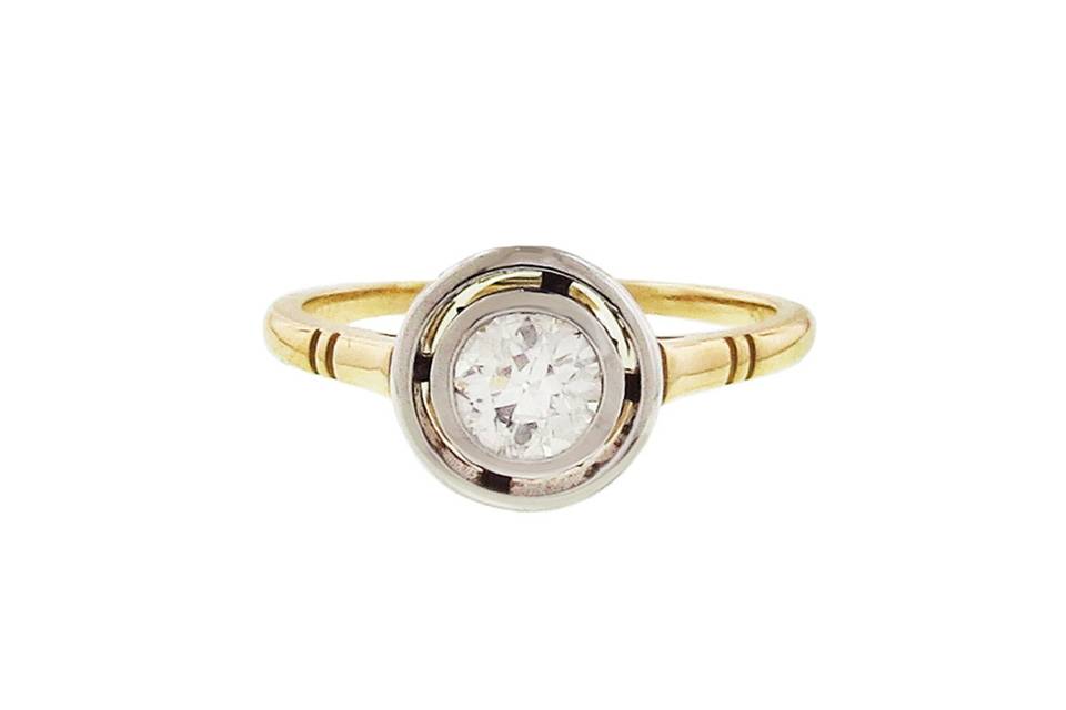 This spectacular ring from Lori McLean is a sleek refreshing take on this classic design. A .50 carat Old European Cut Diamond rests in floating setting of 18 karat white gold. The diamond is bezel set and is finished on a high polish 18 karat gold band with detailed etching. Celebrate your love by gifting this ring for your special engagement or anniversary.