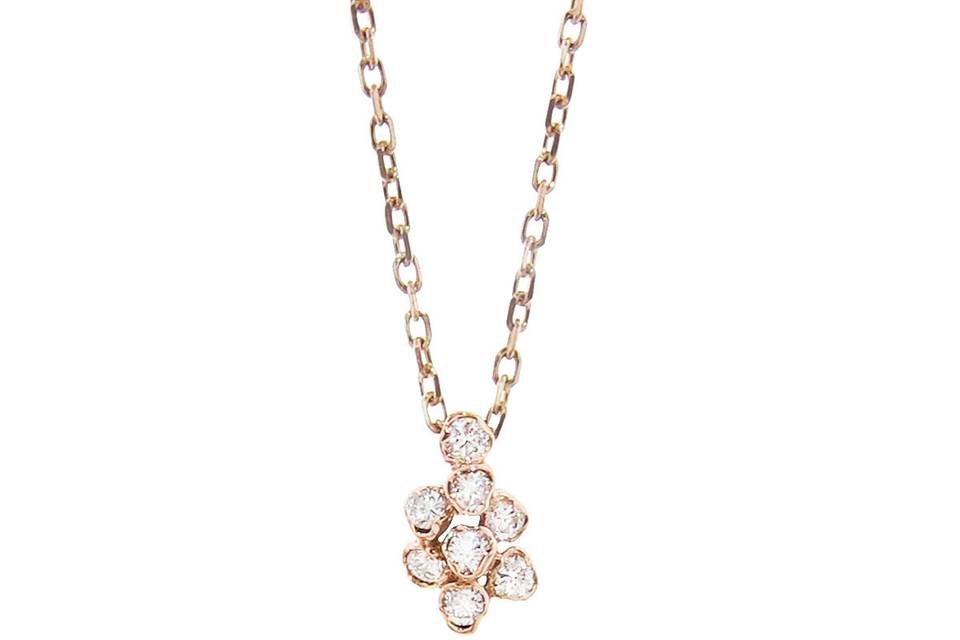 This romantic flower necklace from Kataoka blooms with individuality and organic design. Individually bezel set diamonds create a tiny delicate flower that pops in its 18 karat rose gold setting. The diamonds total .08 carats. This diamond cluster measures 1/4