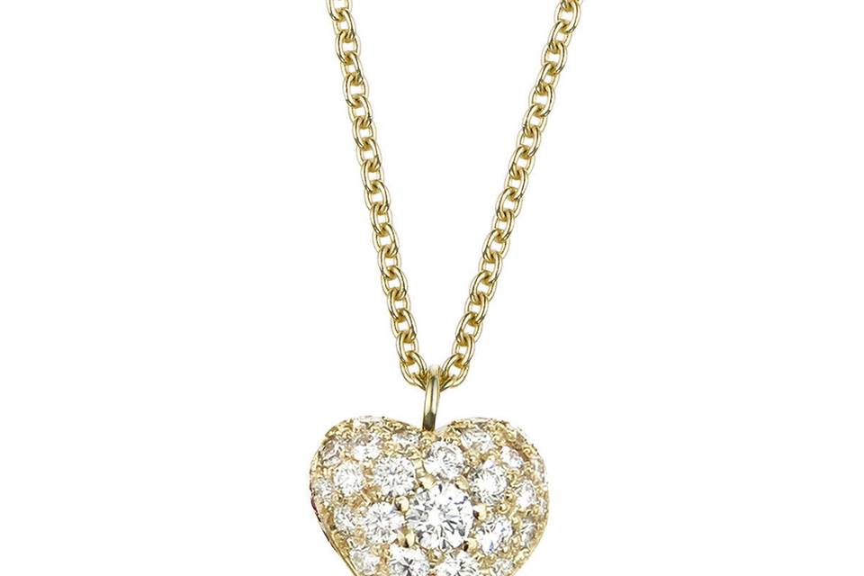 This delicate necklace from Finn is composed of 18 karat yellow gold and features a tiny puffed heart with bright diamond detailing. The pendant measures a tiny 1/4