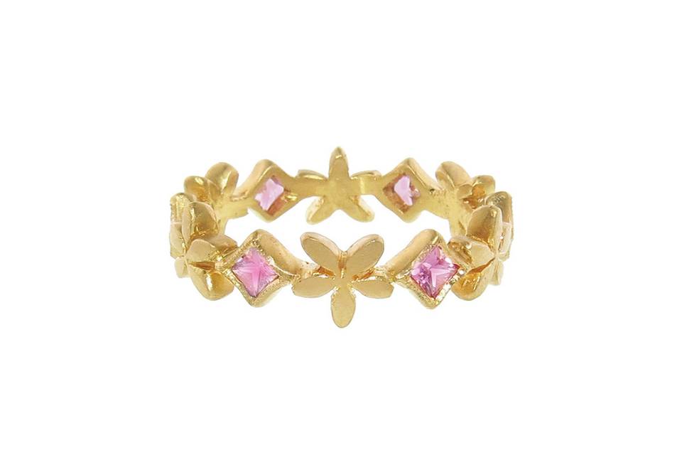This gorgeous ring from Cathy Waterman gives a stylish, sweet twist to a classic 22 karat gold band. Delicate pink sapphires bezel set in gold are placed around the band uniting gold flowers. A simple and sweet addition to your everyday stack or mix and match this ring with Cathy’s other bands to create your own signature look.