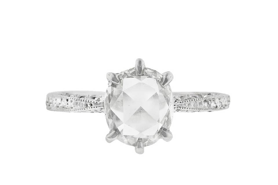 This antique-inspired diamond solitaire from Cathy Waterman has a quietly understated feminine elegance. This ring is detailed by hand to perfection, a large rose cut diamond that totals 1.17 carats is prong set in platinum. The diamond rests on a hand-engraved platinum band with diamond pavé set along the entire band. This stunning ring is perfect for an engagement or other special occasion.