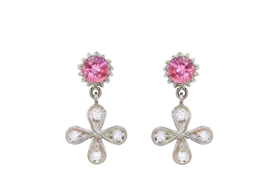 Add a hint of sparkle to your everyday look with these Cathy Waterman 4 petal flower earrings. Soft pink sapphires top these earrings and rest in Cathy's platinum spider prong setting. A 4 petal flower featuring white diamonds and intricate etching dangles from each sapphire. The flowers are detailed in .12 carats worth of diamonds and the sapphires total .61 carats. These earrings measure 5/8