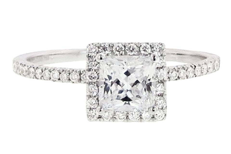 This setting from Hidalgo is composed of 18 karat white gold, thin micro pave diamond band with diamond setting that accommodates a princess cut diamond. The diamonds are set half way down the band. Please inquire about sizing options. Please note that the center stone in this ring is a cubic zirconia. This setting is sold as is. Please call us with inquiries about locating a diamond.