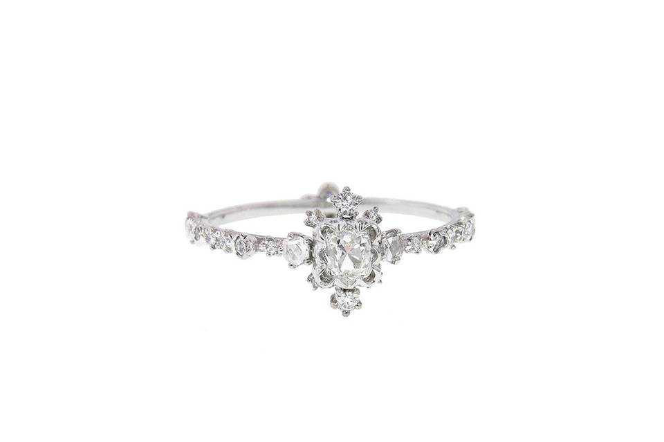 This delicate ring from Kataoka is fashioned in 18 karat white gold and has the most amazing hand detailing. A notched band is host to a gorgeous brilliant cut diamond in a scalloped bead frame, tiny brilliant cuts 'floating' along the setting and set in the band. The diamonds total .50 carats and the ring is a size 6 1/2.