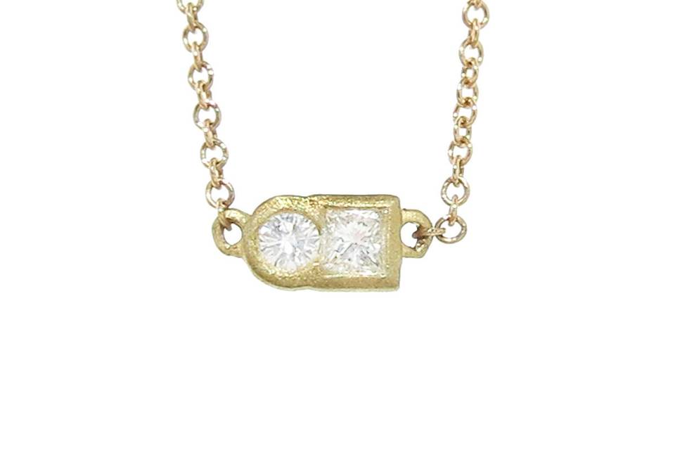This fun shape diamond necklace from Tate is a great layering piece. A square and circle diamond are fused together and bezel set in 18 karat gold. The pendant measures 3/16