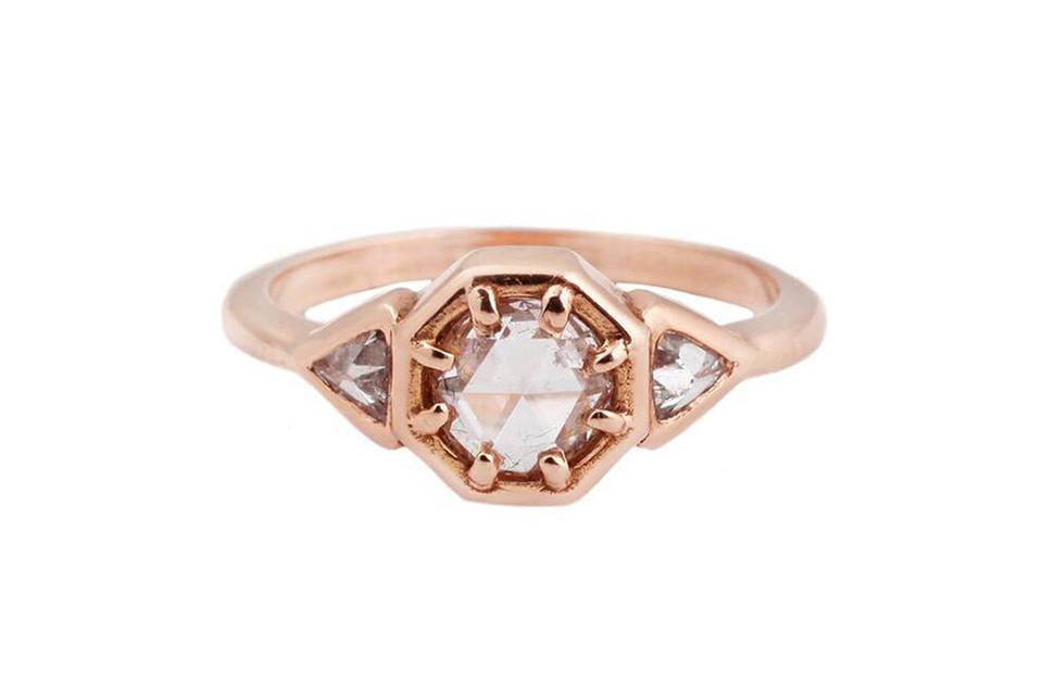 This unique ring from Lauren Wolf will captivate every room. A dazzling rose cut diamond is prong set in a edgy rose gold octagon setting in the center of this ring. Two bezel set, clear, trillion diamonds rest on either side of the octagon setting. Finished on a high polished, thin, rose gold band. This ring is perfect for celebrating an anniversary, birthday or special occasion.
Crafted in 18 karat rose gold
Diamonds total .43 carats.
Handcrafted in California.