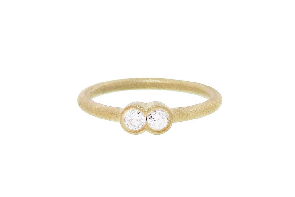 Minimalist in style this ring from Tate is gorgeous alone or stacked with your favorite rings. Bezel set in 18 karat gold two fused diamonds rest on a thin gold band.