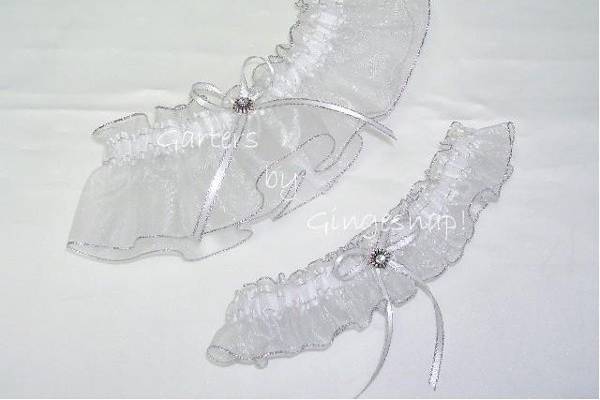 Swarovski Sparkling Silver Garter Set.
Made from sheer white organza material trimmed in thin sparkling silver edging and a coordinating band.