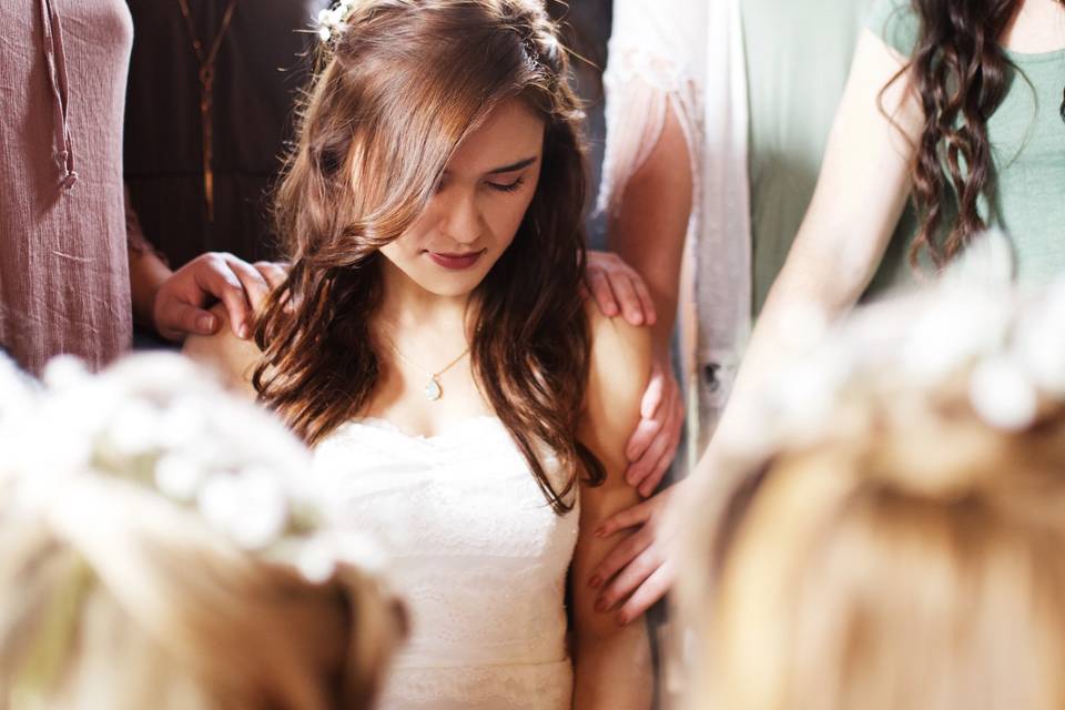 Group prayer over bride