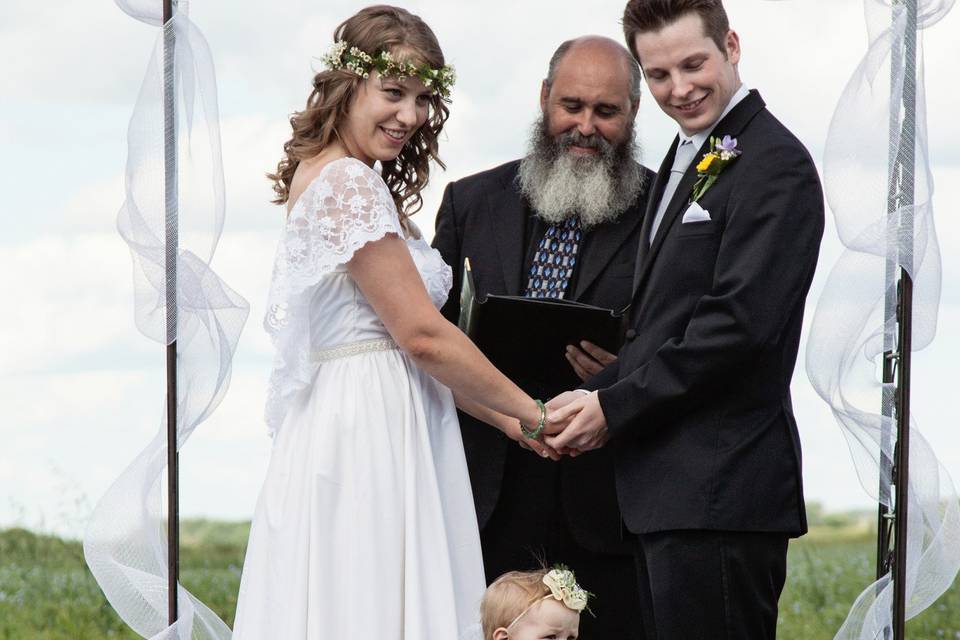 Samantha of Canada is wearing her completely reworked 1980s wedding dress to her barefoot outdoor wedding accompanied by this adorable angel!