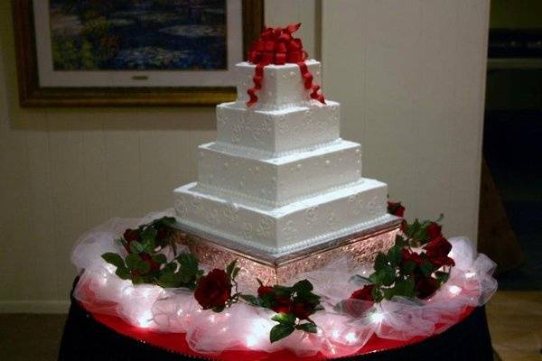 A Red Themed Wedding Cake Table Close up
