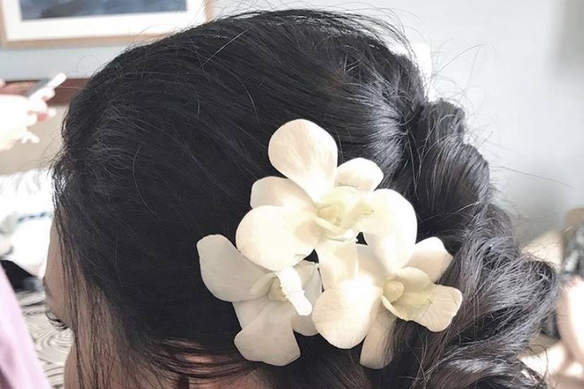 Messy updo with orchid flowers