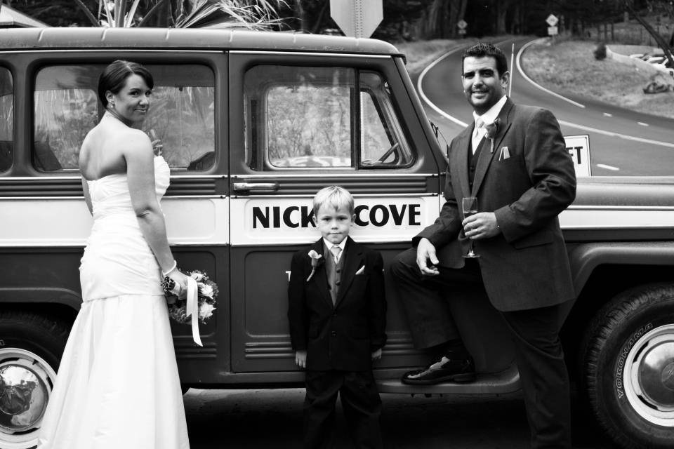Newlyweds and the little boy by the car