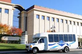 A white 29 passenger mini coach