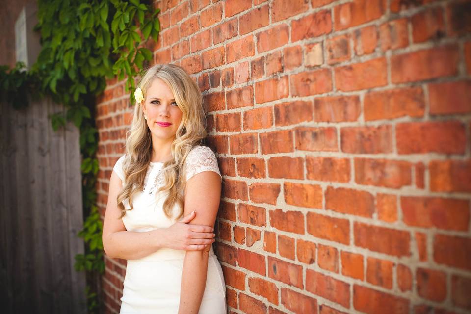 Bride by the brick wall