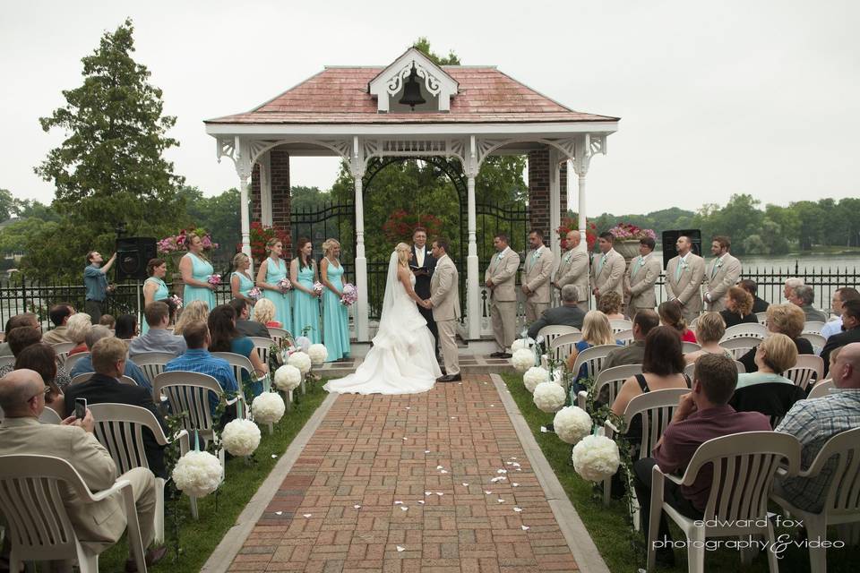 Wedding ceremony with guests, bridesmaid, and groomsmen