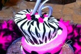 Topsy turvey birthday cake with fondant ribbon roses, fondant bows and zebra print.