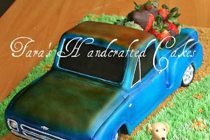 Carved truck 3D cake to look like grooms truck. Bed of truck filled with chocolate dipped strawberries. Fondant sculpted dog, 