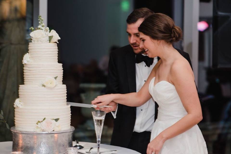 The couple cutting the cake