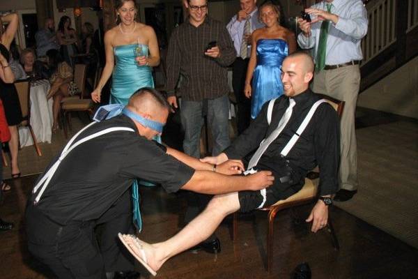Having some fun playing a trick on the gentleman who caught the garter.