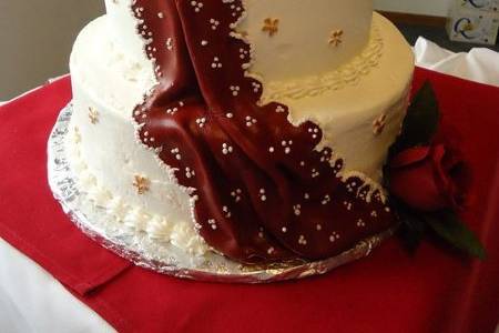 Burgundy and gold sari wedding cake. Butter cream frosting with fondant embellishments.