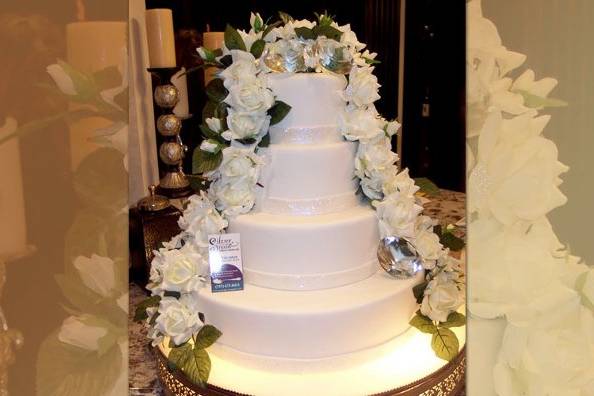 This four tiered beauty was all sparkles. Large crystal diamonds accented the top of the cake while white roses softly cascade the sides of the tower.