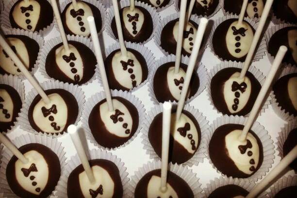 As long as he has his suit and tie... These luscious cake balls were on parade at a gentleman surprise, formal birthday party. Red velvet cake was pleasantly enrobed in white and dark chocolate. YUM!