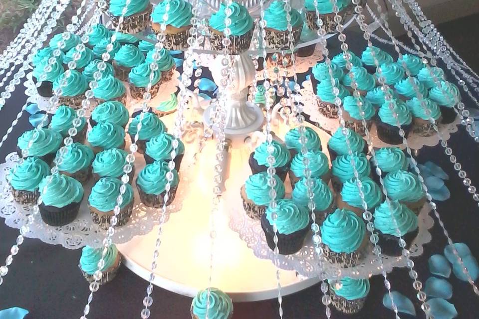Meet Monique. This cupcake queen demanded attention when you entered the room. Chocolate and vanilla cupcakes were carefully placed on this chandelier cake stand while crystals draped from the anniversary cake that was tiramisu of course, and cascaded to the floor.