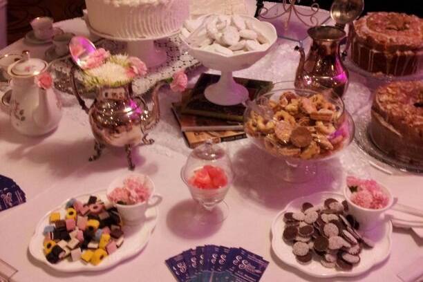 Our vintage dessert table was displayed wonderfully in the ballroom of a hotel. Traditional pound cakes and authentic tea cookies were also on display. The table was adorned with silver teapots and servers as well as antique china.