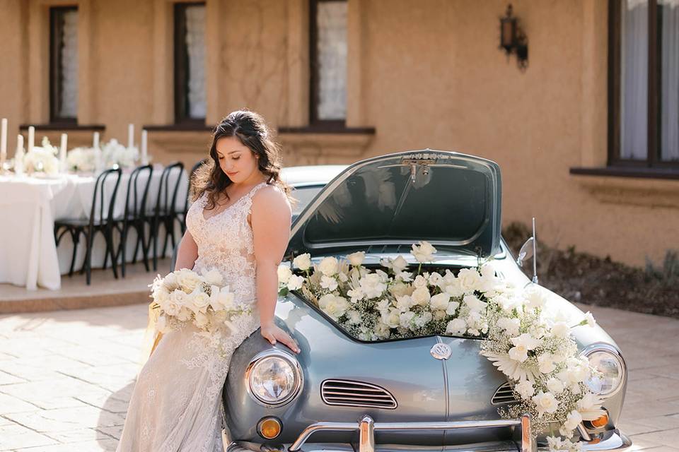 Bride by a vintage car