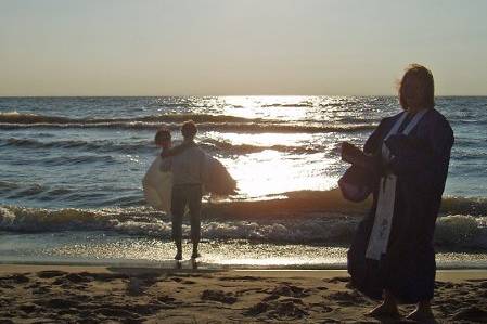 Just after the ceremony, he swept her up and they went into the waves.