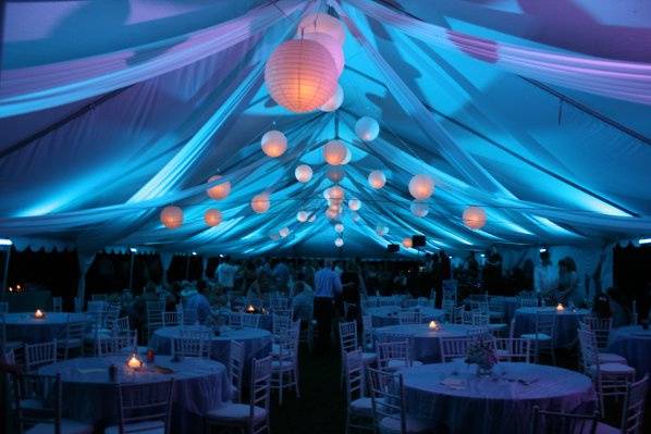 Fabric draped from the ceiling, accented by lighting set the tone for this reception. Ball lanterns were hung from the ceiling to tie into the couple's theme.