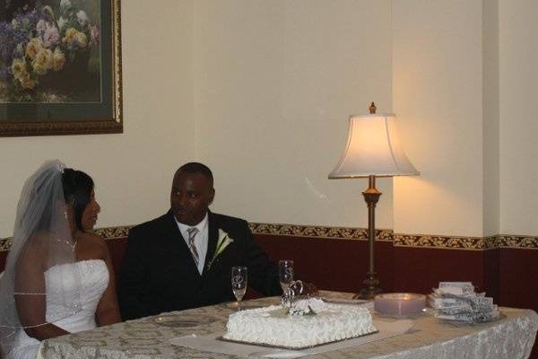 Bride and groom with wedding cake.