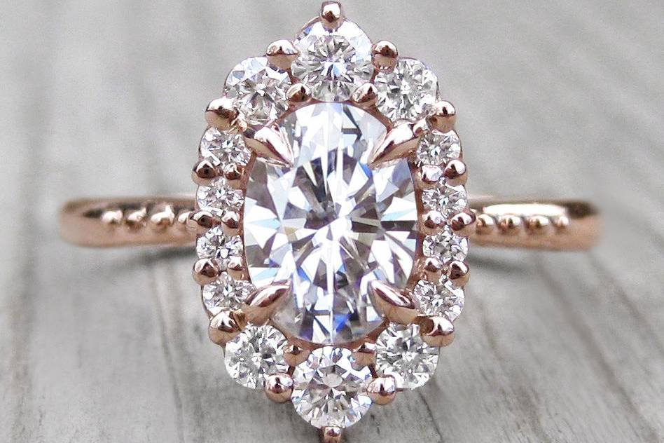 The small Sofia, a forever one oval moissanite with conflict-free canadian diamond halo in rose gold