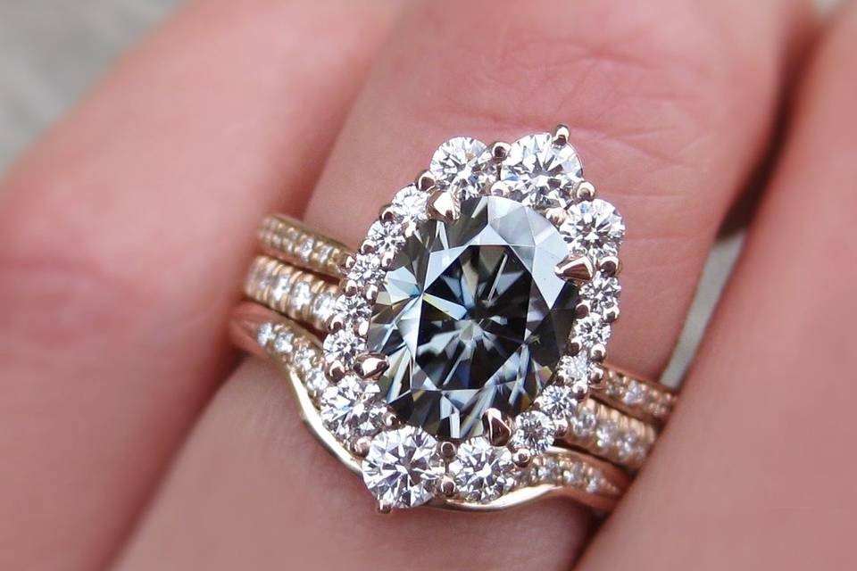 The large Sofia, an Iconic grey oval moissanite and diamond halo