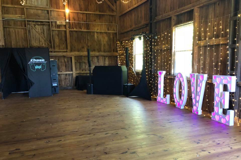 Photo booth, DJ setup, and love sign