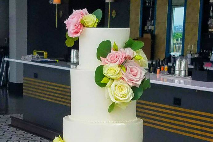 Pink flowers on wedding cake